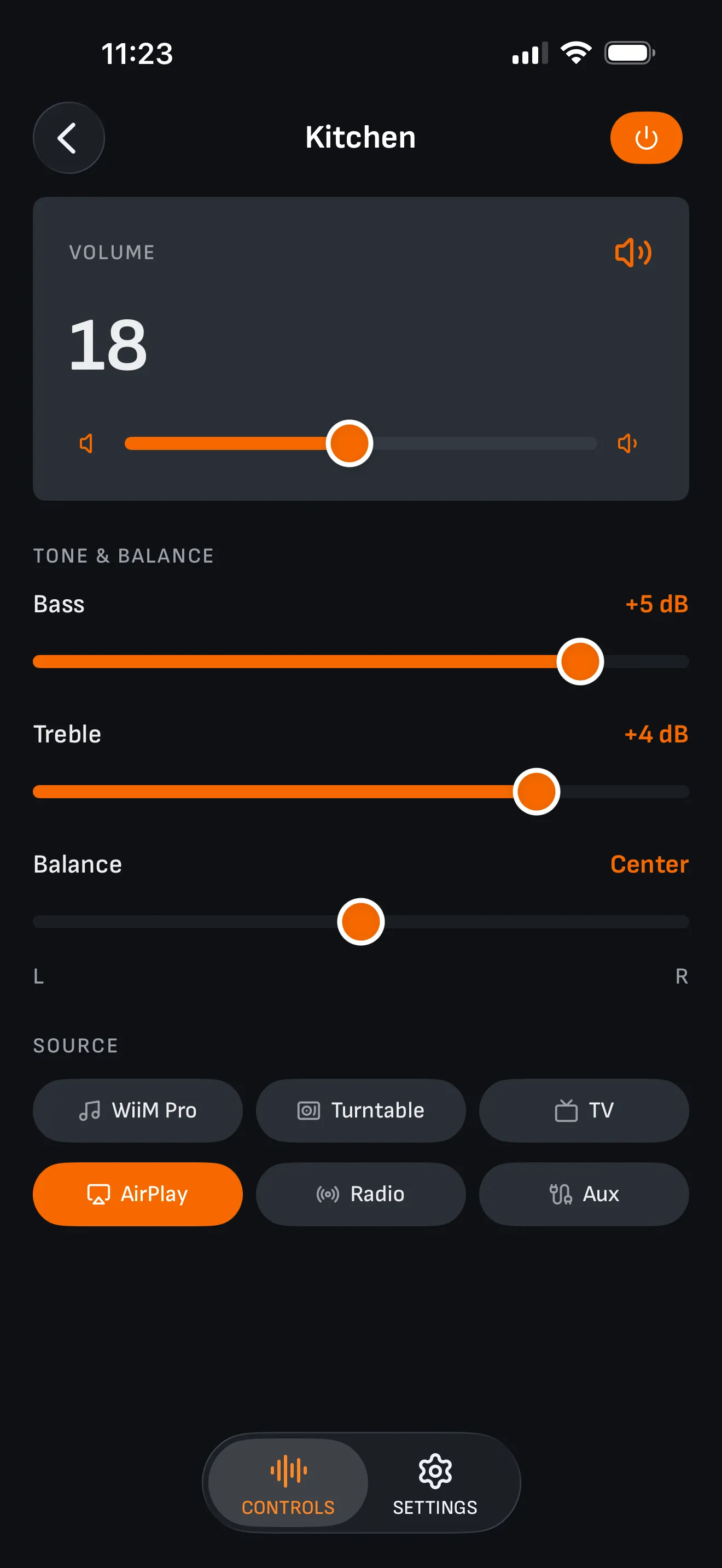 The Kitchen zone: bass at +5 dB, treble at +4 dB, balance centered between L and R, and the source buttons beneath — AirPlay selected, with Radio and Aux beside it.